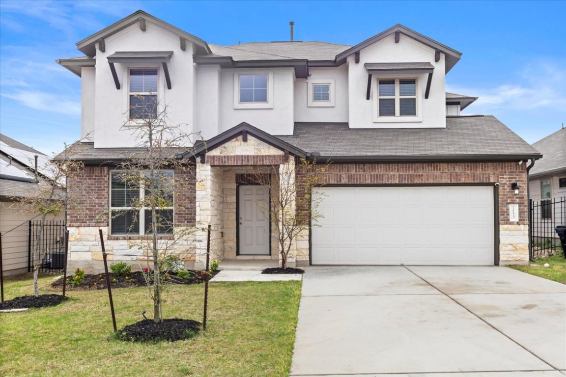 213 Munk Lane Leander, TX 78641 - Photo 5 of 40 a front view of a house with garden