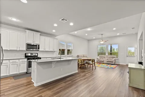 a kitchen with stainless steel appliances a refrigerator sink and microwave