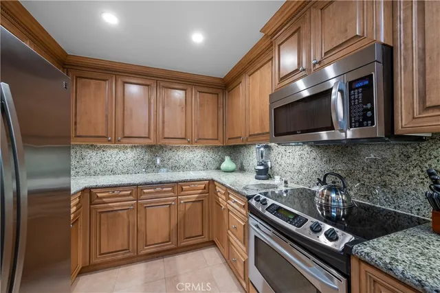 a kitchen with stainless steel appliances granite countertop a sink stove and microwave