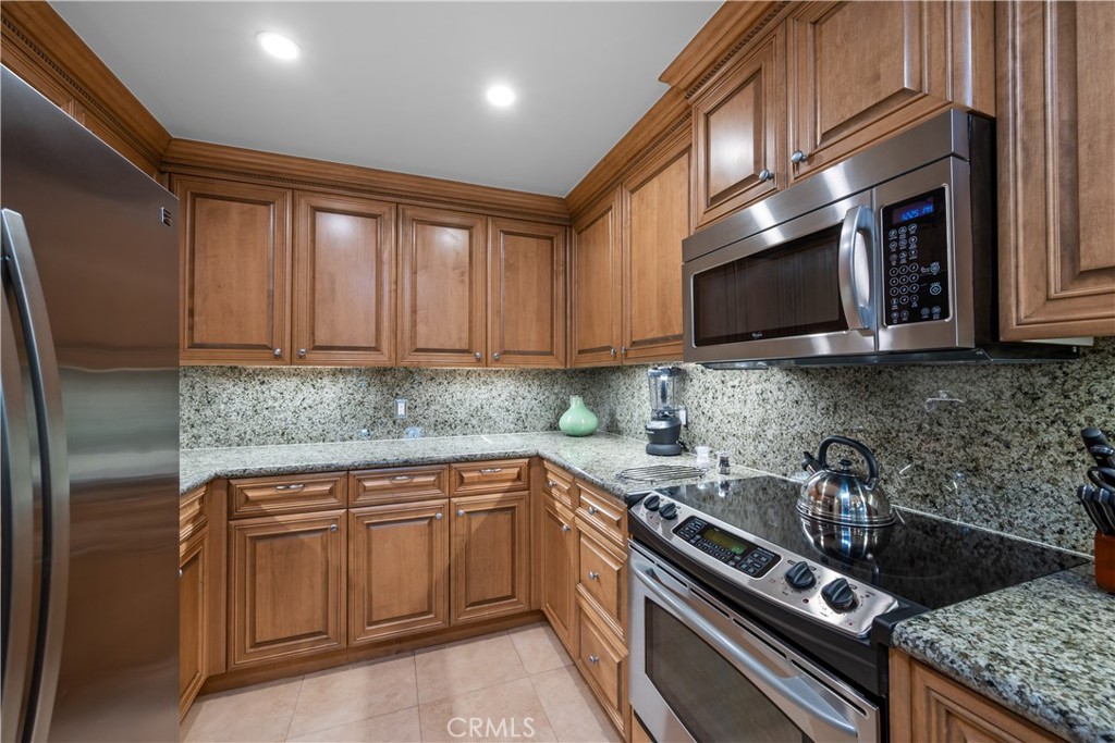 2727 Shell Beach Road, Unit 219 Pismo Beach, CA 93449 - Photo 11 of 35 a kitchen with stainless steel appliances granite countertop a sink stove and microwave