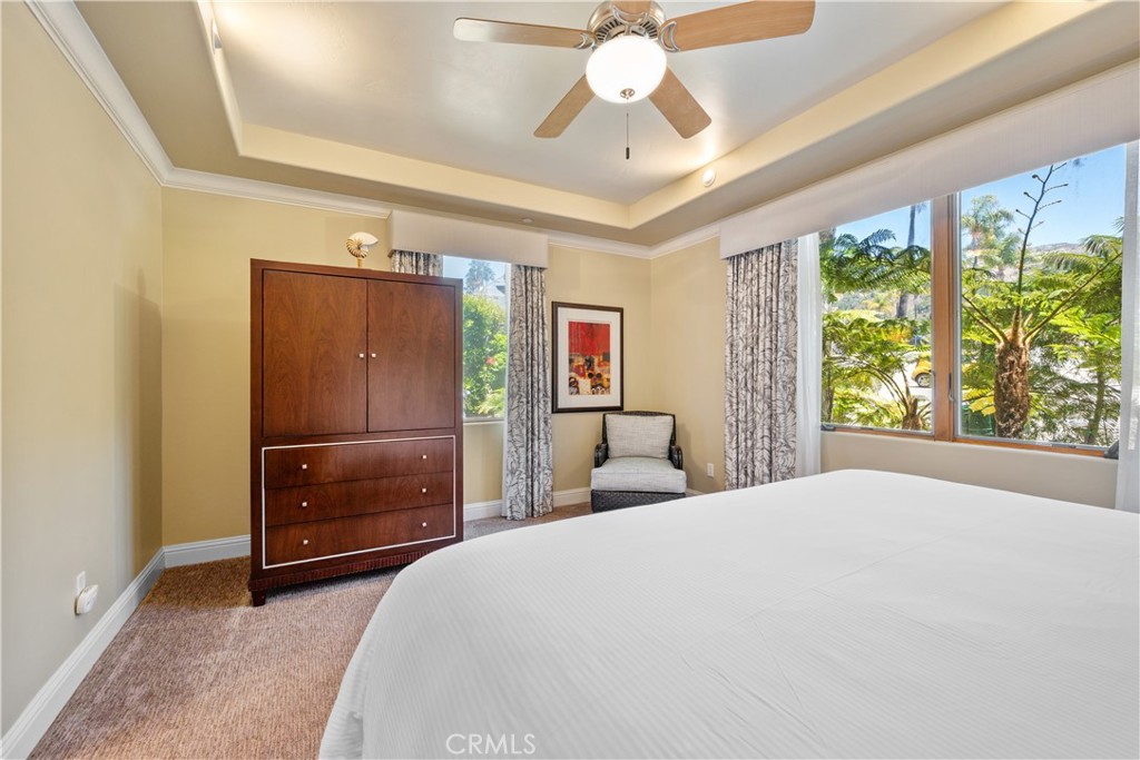 2727 Shell Beach Road, Unit 219 Pismo Beach, CA 93449 - Photo 15 of 35 a bedroom with a bed and a chandelier