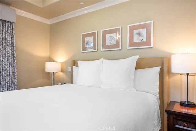 a large bed sitting in a bedroom next to a lamp