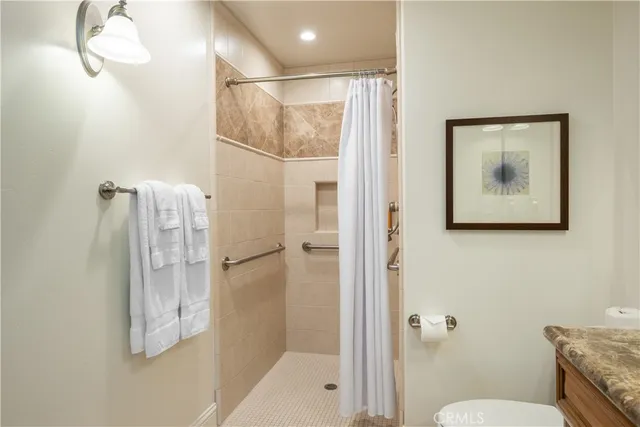 a bathroom with a shower and toilet