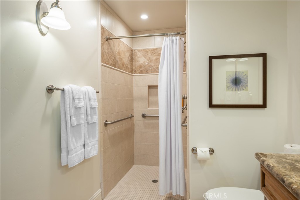 2727 Shell Beach Road, Unit 219 Pismo Beach, CA 93449 - Photo 18 of 35 a bathroom with a shower and toilet