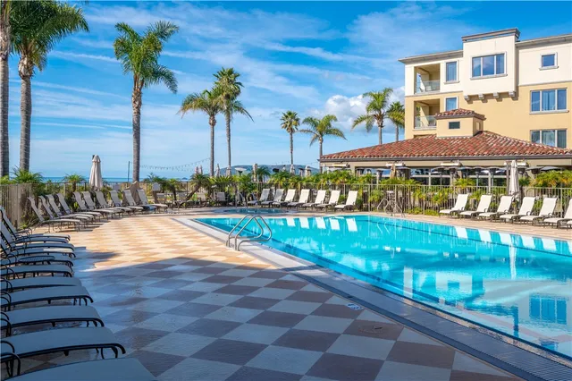 a vase of flowers sitting on a floor in front of a building