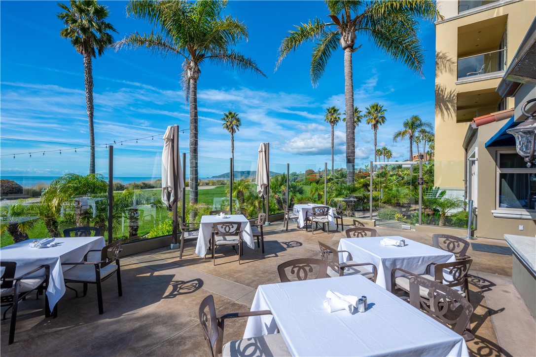 2727 Shell Beach Road, Unit 219 Pismo Beach, CA 93449 - Photo 31 of 35 a view of a backyard with a patio table and chairs
