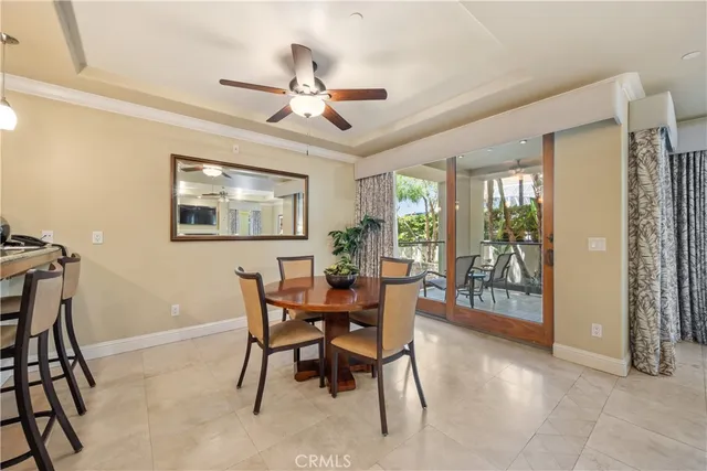 a dining room with furniture a chandelier and wooden floor