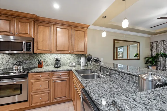 a kitchen with stainless steel appliances granite countertop a sink stove and cabinets