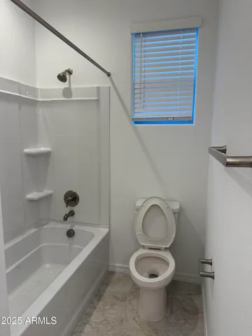a bathroom with a toilet a sink and bathtub