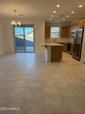 a large kitchen with stainless steel appliances granite countertop a sink and cabinets