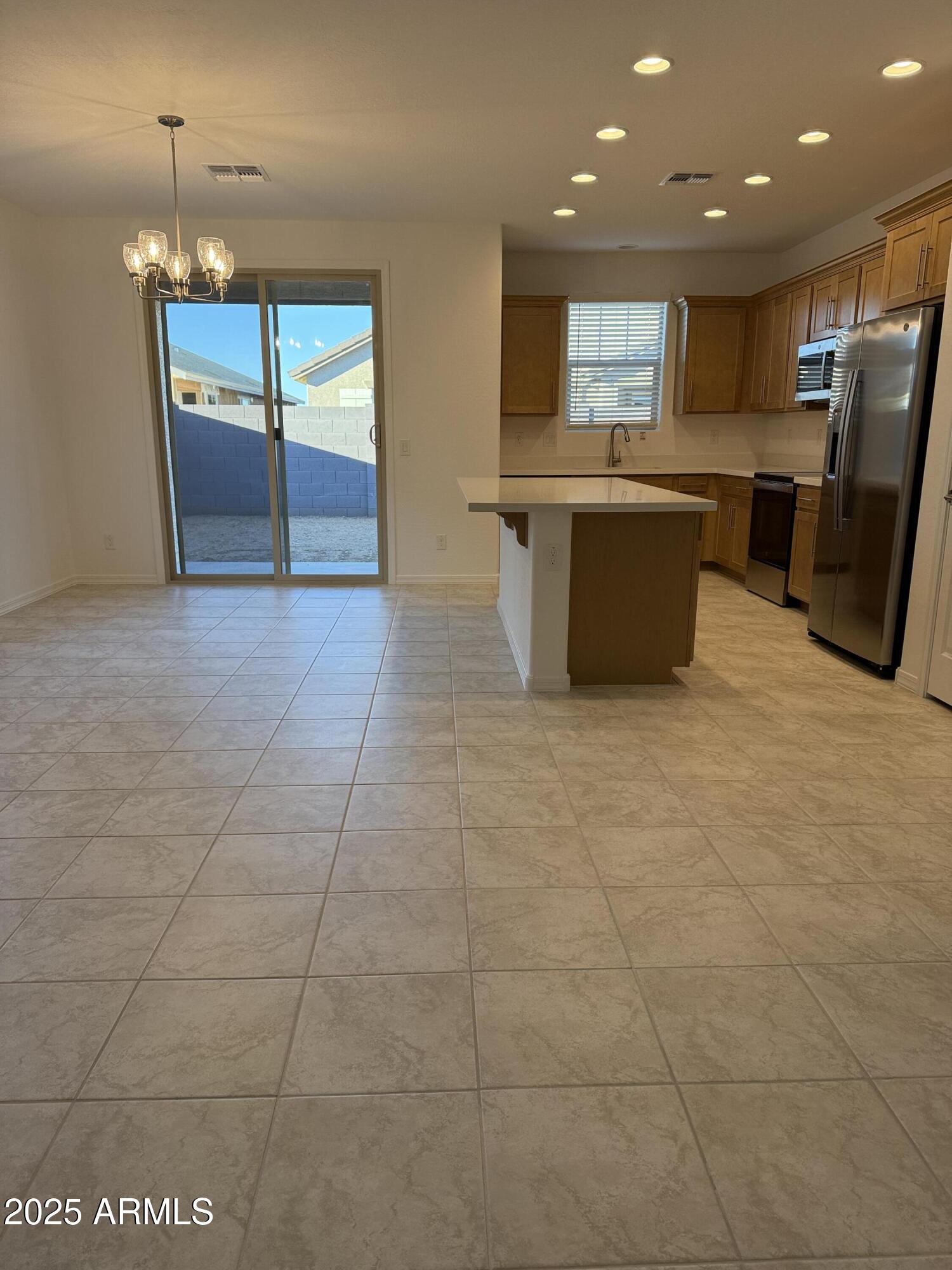 9960 West Mitchell Avenue Avondale, AZ 85392 - Photo 2 of 25 a large kitchen with stainless steel appliances granite countertop a sink and cabinets