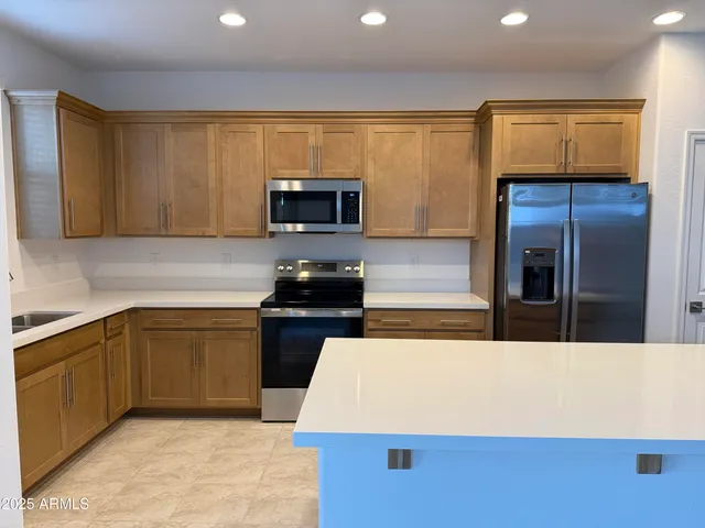 a kitchen with stainless steel appliances a stove microwave and refrigerator