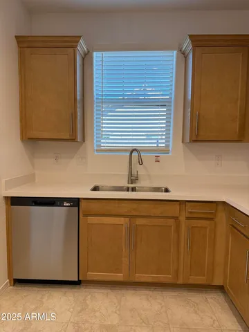 a kitchen with stainless steel appliances granite countertop a sink and a microwave