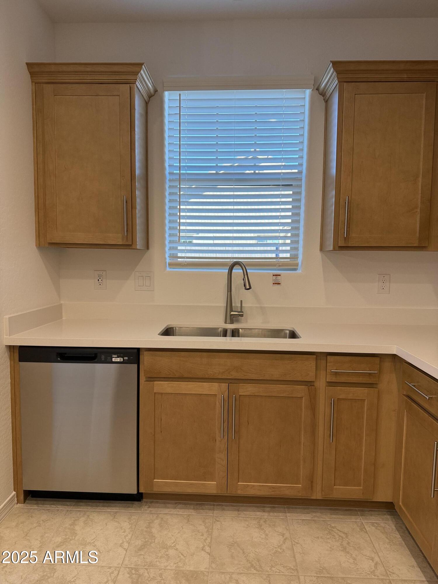 9960 West Mitchell Avenue Avondale, AZ 85392 - Photo 6 of 25 a kitchen with stainless steel appliances granite countertop a sink and a microwave