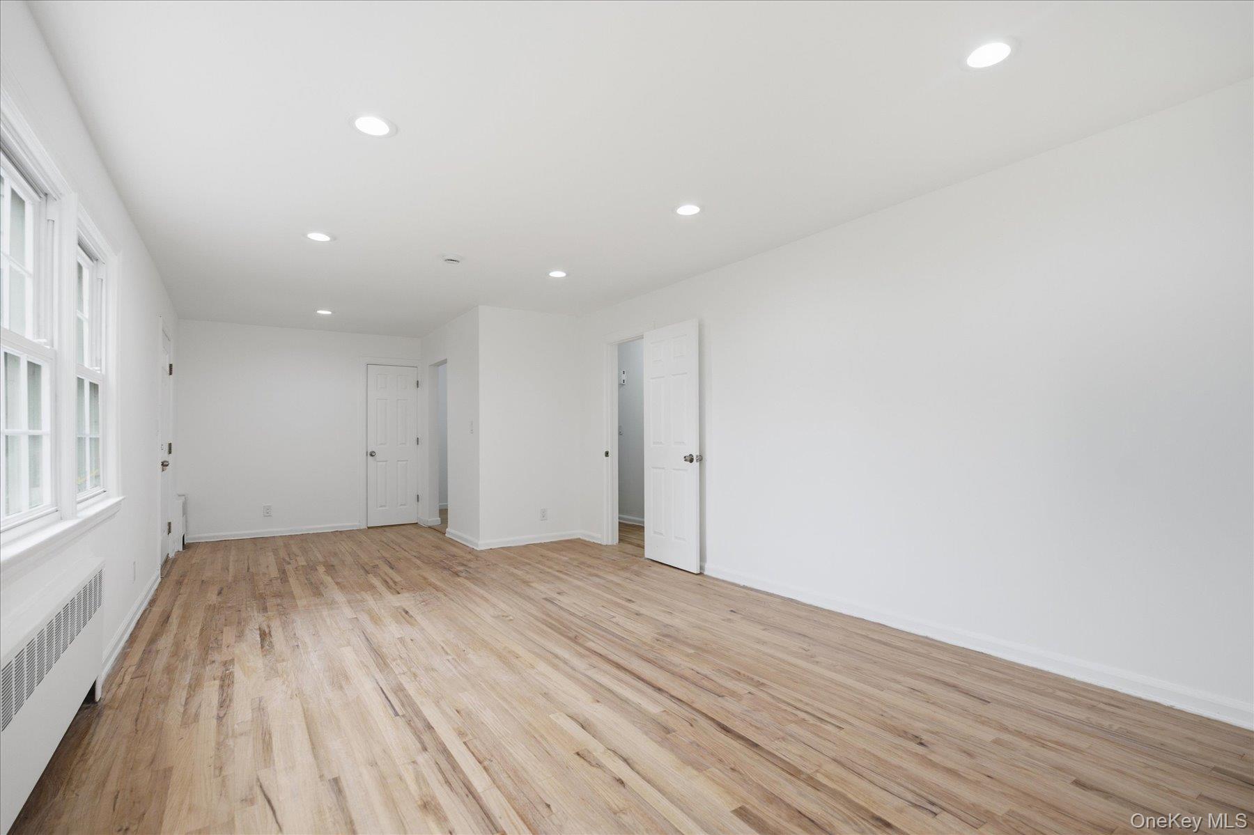 117 Robins Road, Unit 117 New Rochelle, NY 10801 - Photo 15 of 28 a view of an empty room with wooden floor and a window