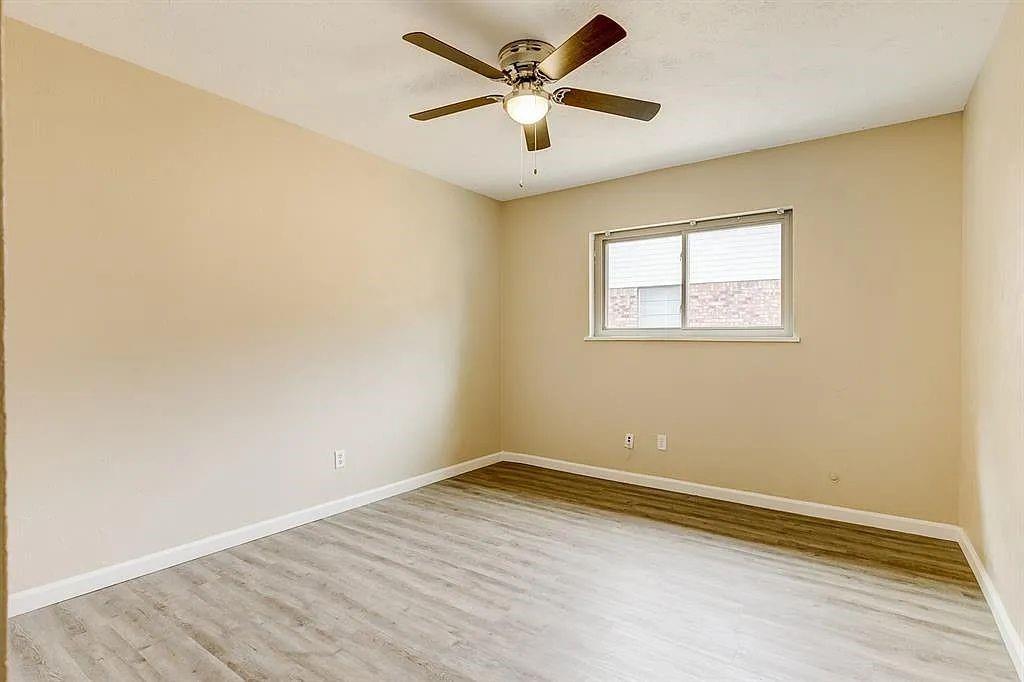 1316 Royster Road Fort Worth, TX 76134 - Photo 11 of 19 an empty room with a window and a ceiling fan