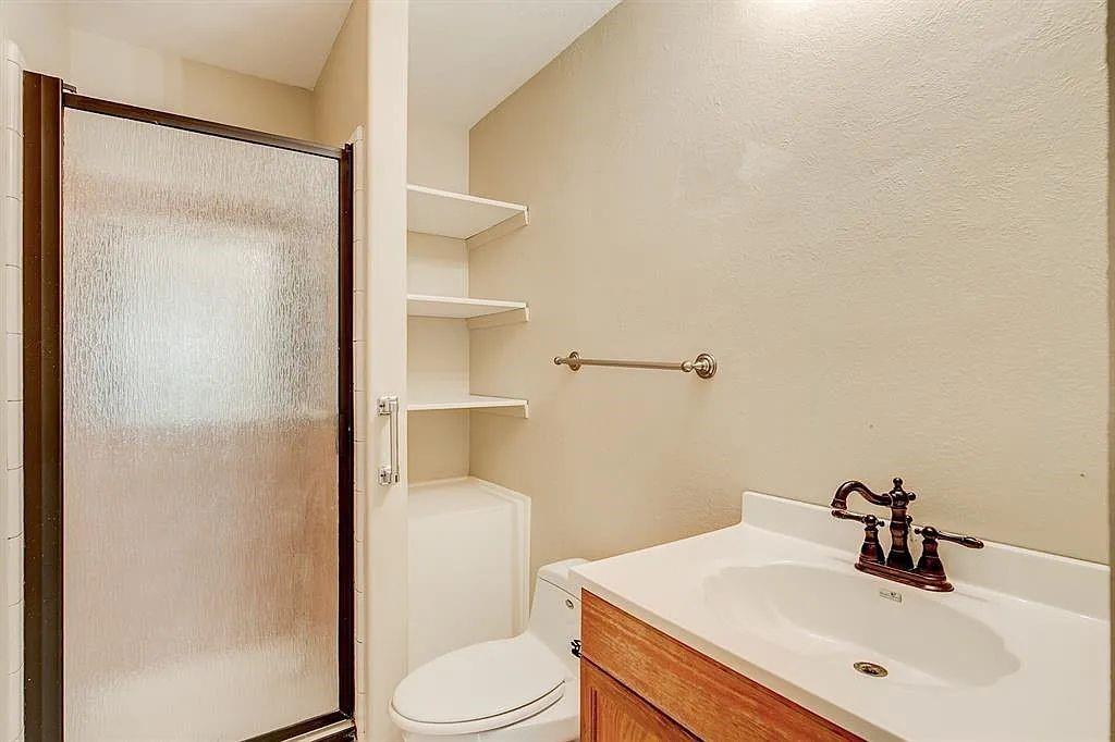 1316 Royster Road Fort Worth, TX 76134 - Photo 12 of 19 a bathroom with a sink toilet and vanity