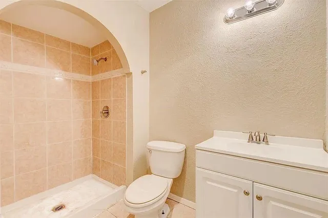 a white toilet sitting next to a bathroom sink