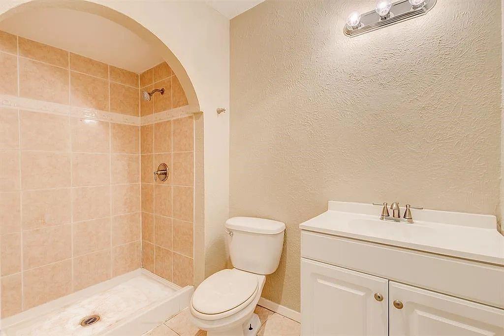 1316 Royster Road Fort Worth, TX 76134 - Photo 14 of 19 a white toilet sitting next to a bathroom sink