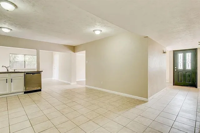 a view of a kitchen with kitchen sink and white cabinets