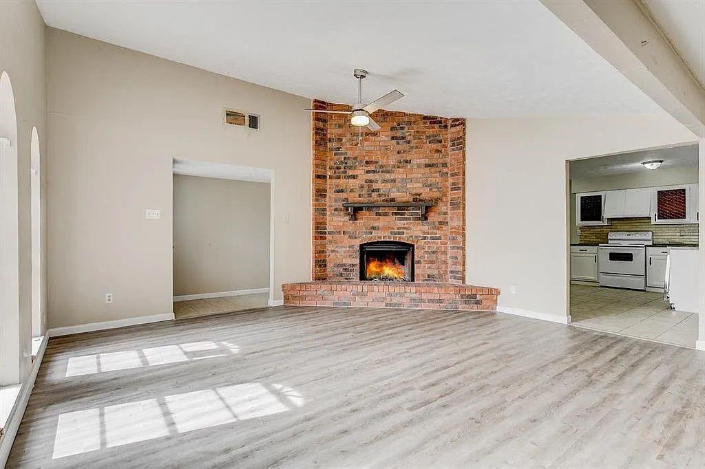 1316 Royster Road Fort Worth, TX 76134 - Photo 4 of 19 a view of empty room with kitchen and fireplace