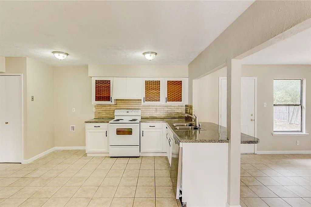 1316 Royster Road Fort Worth, TX 76134 - Photo 7 of 19 a kitchen with a stove a sink and a refrigerator