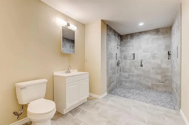a bathroom with a toilet sink and shower