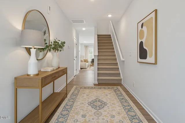a view of entryway and hall with wooden floor