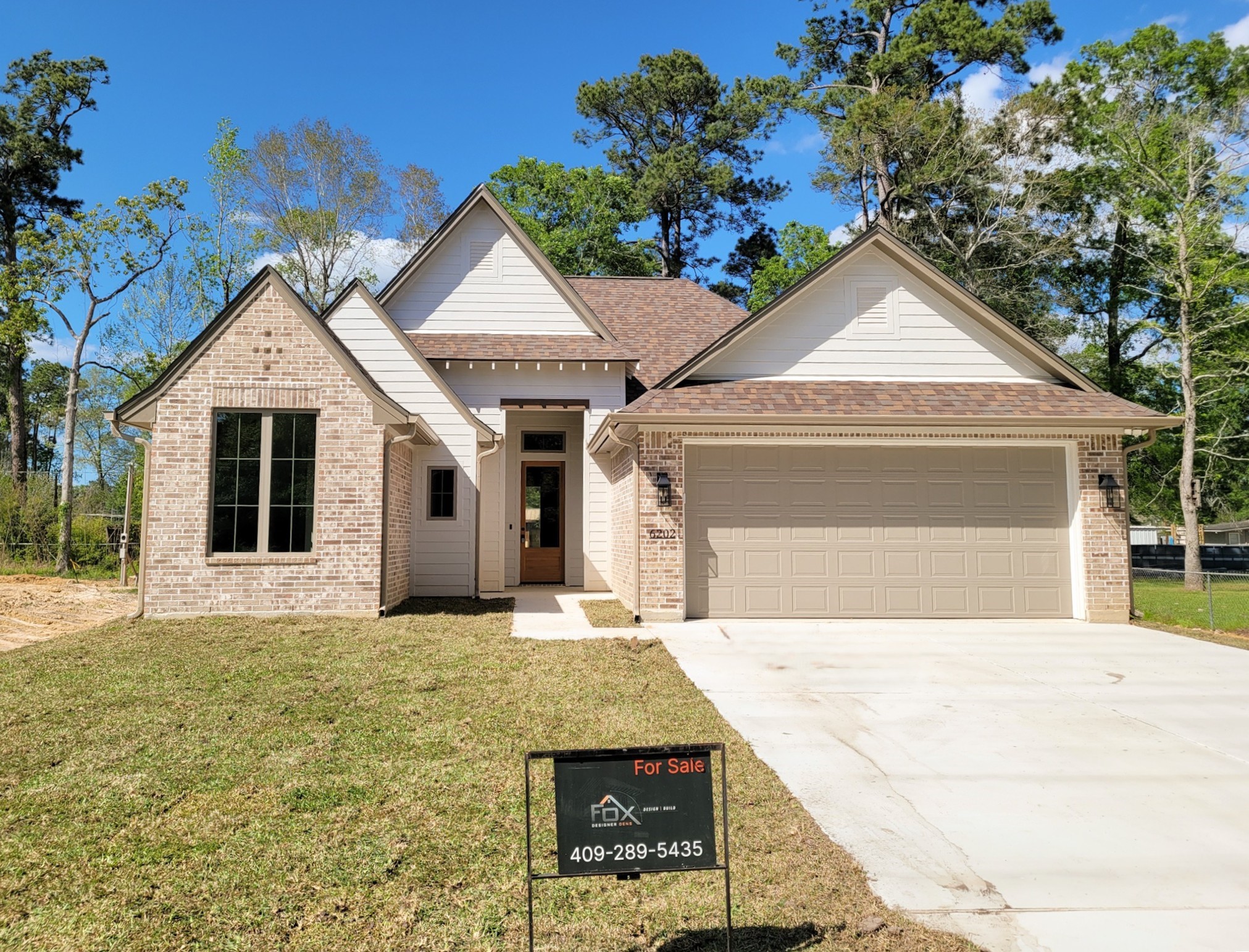 6202 Johnson Road Orange, TX 77632 - Photo 1 of 26 a front view of a house with a yard and garage