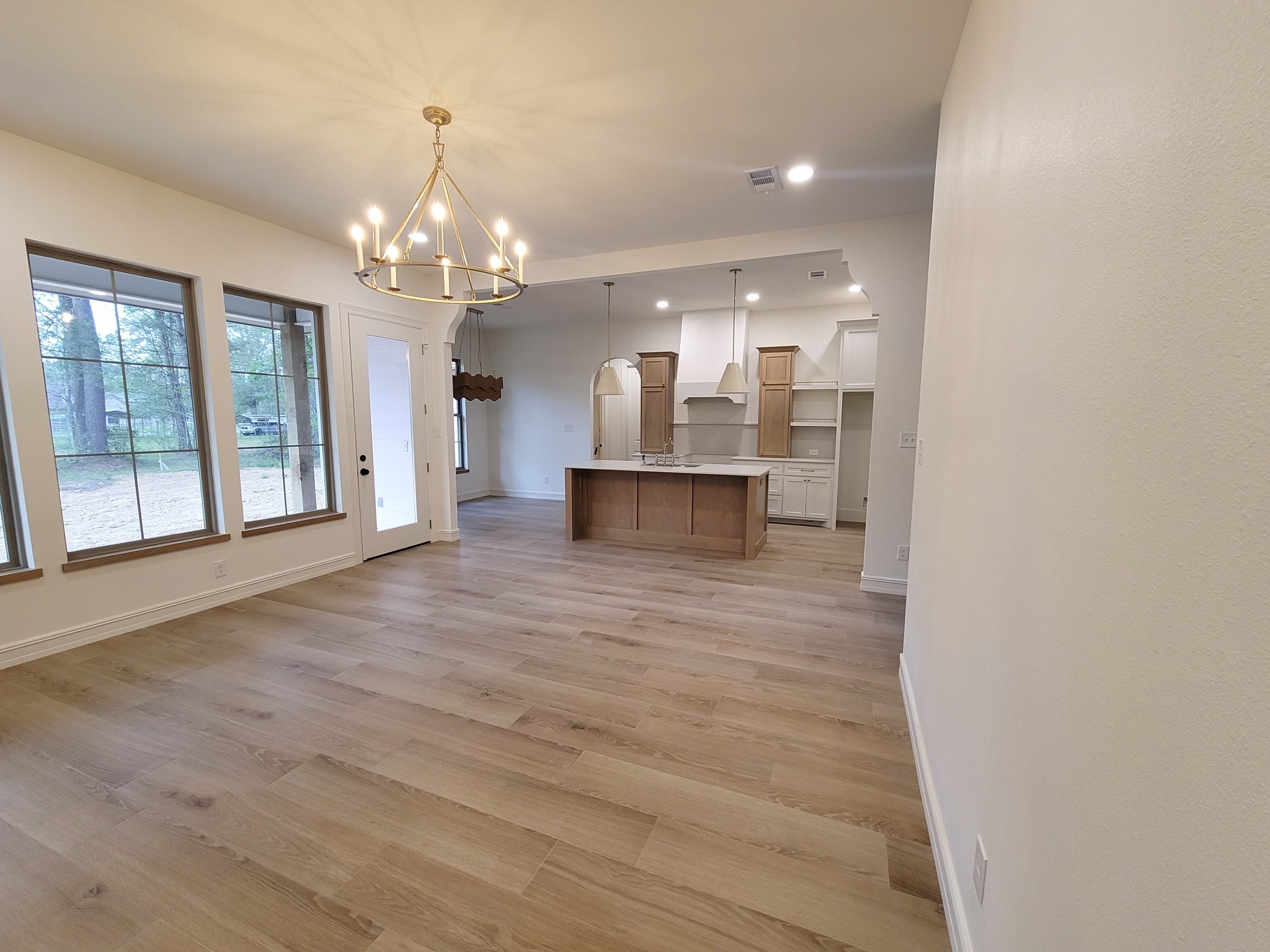 6202 Johnson Road Orange, TX 77632 - Photo 8 of 26 a view of a big room with chandelier and windows
