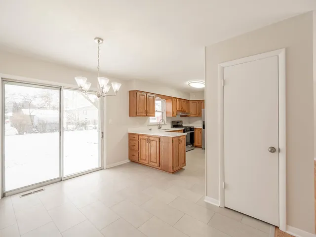 a open kitchen with a refrigerator a sink and a stove