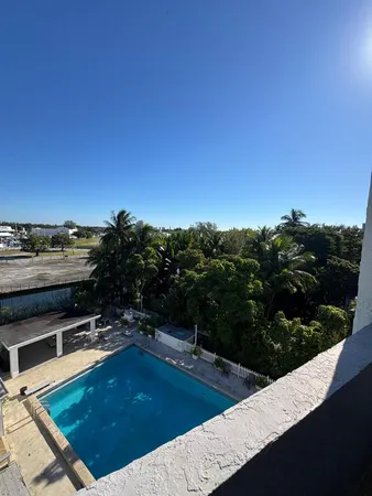 a view of a swimming pool and lounge chair