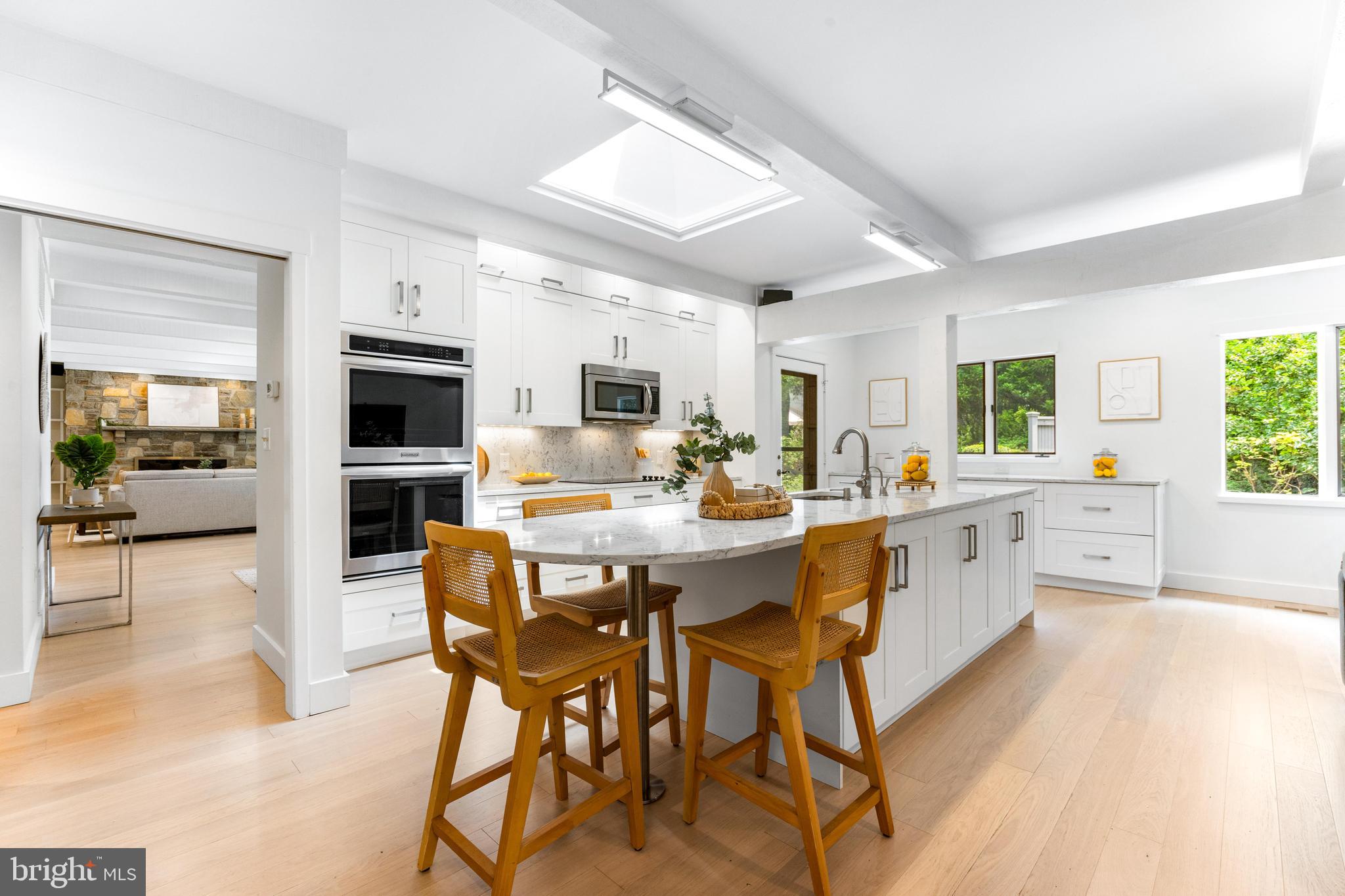 5 Tall Tree Court Baltimore, MD 21208 - Photo 24 of 78 a kitchen with stainless steel appliances kitchen island granite countertop a table chairs sink and cabinets