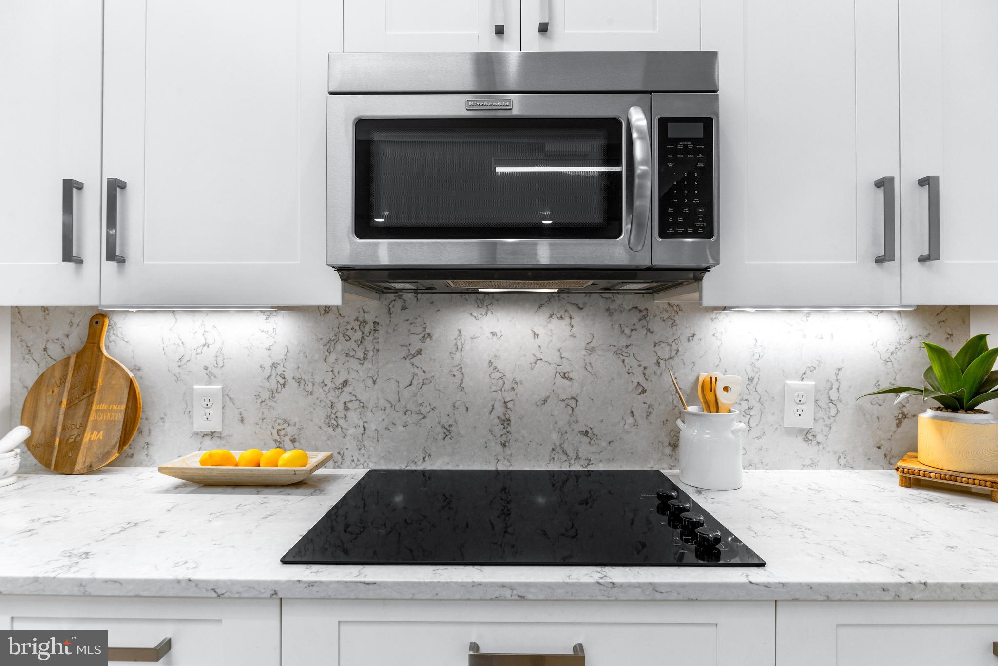 5 Tall Tree Court Baltimore, MD 21208 - Photo 32 of 78 a kitchen with a stove and a microwave
