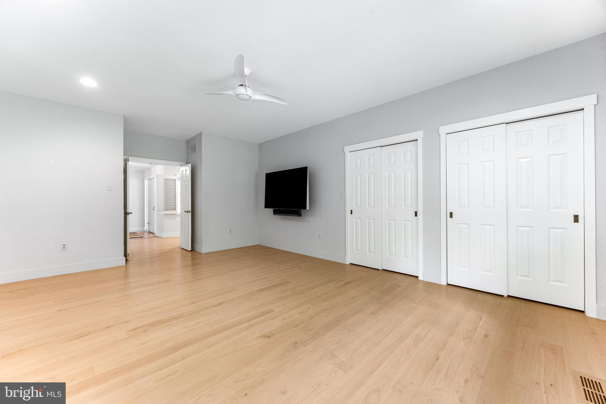 5 Tall Tree Court Baltimore, MD 21208 - Photo 56 of 78 a view of an empty room with wooden floor and a window