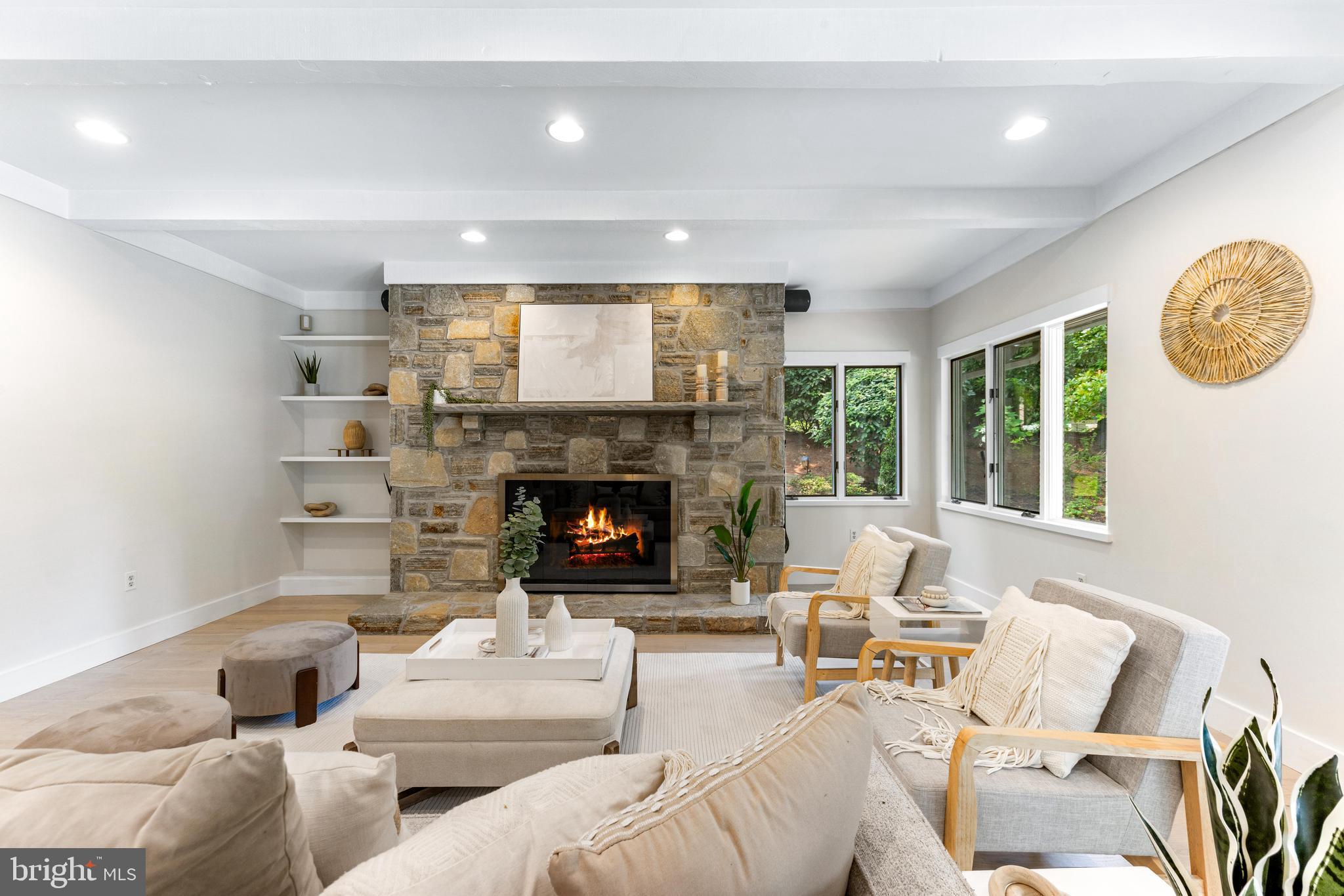 5 Tall Tree Court Baltimore, MD 21208 - Photo 10 of 78 a living room with furniture a fireplace and a large window