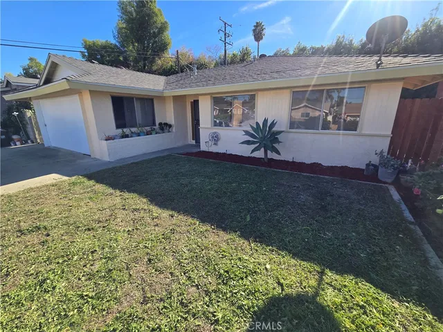 a view of a house with backyard and porch