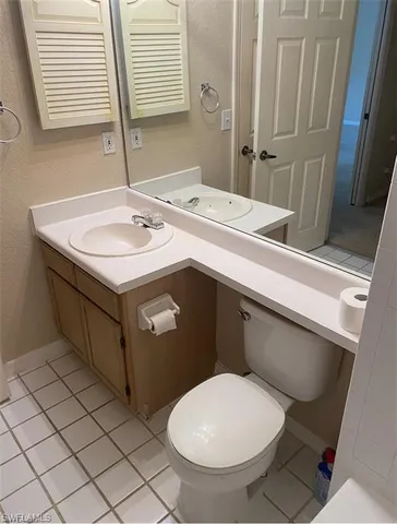 a bathroom with a sink toilet and mirror