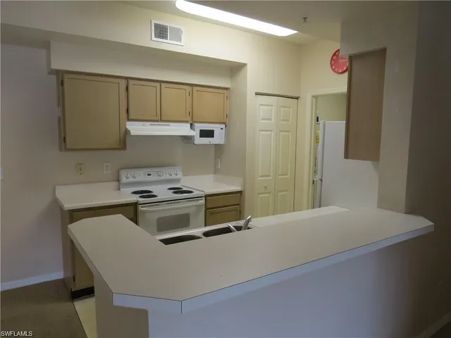a kitchen with a sink cabinets and appliances