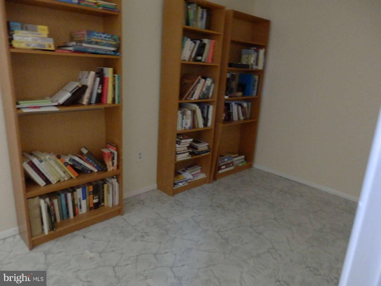 8250 Brattle Road Baltimore, MD 21208 - Photo 14 of 17 a view of a livingroom with shelves