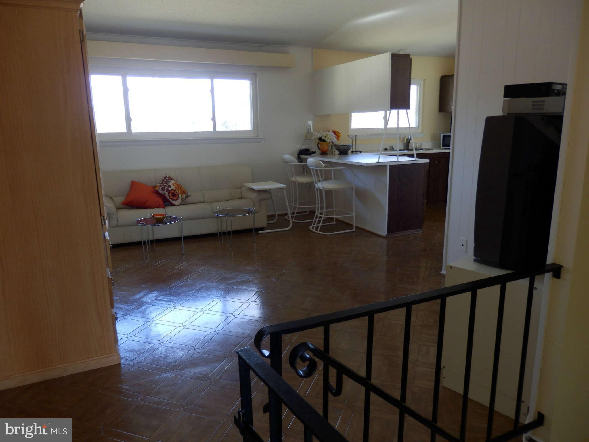 8250 Brattle Road Baltimore, MD 21208 - Photo 6 of 17 a view of a workspace with furniture and a window