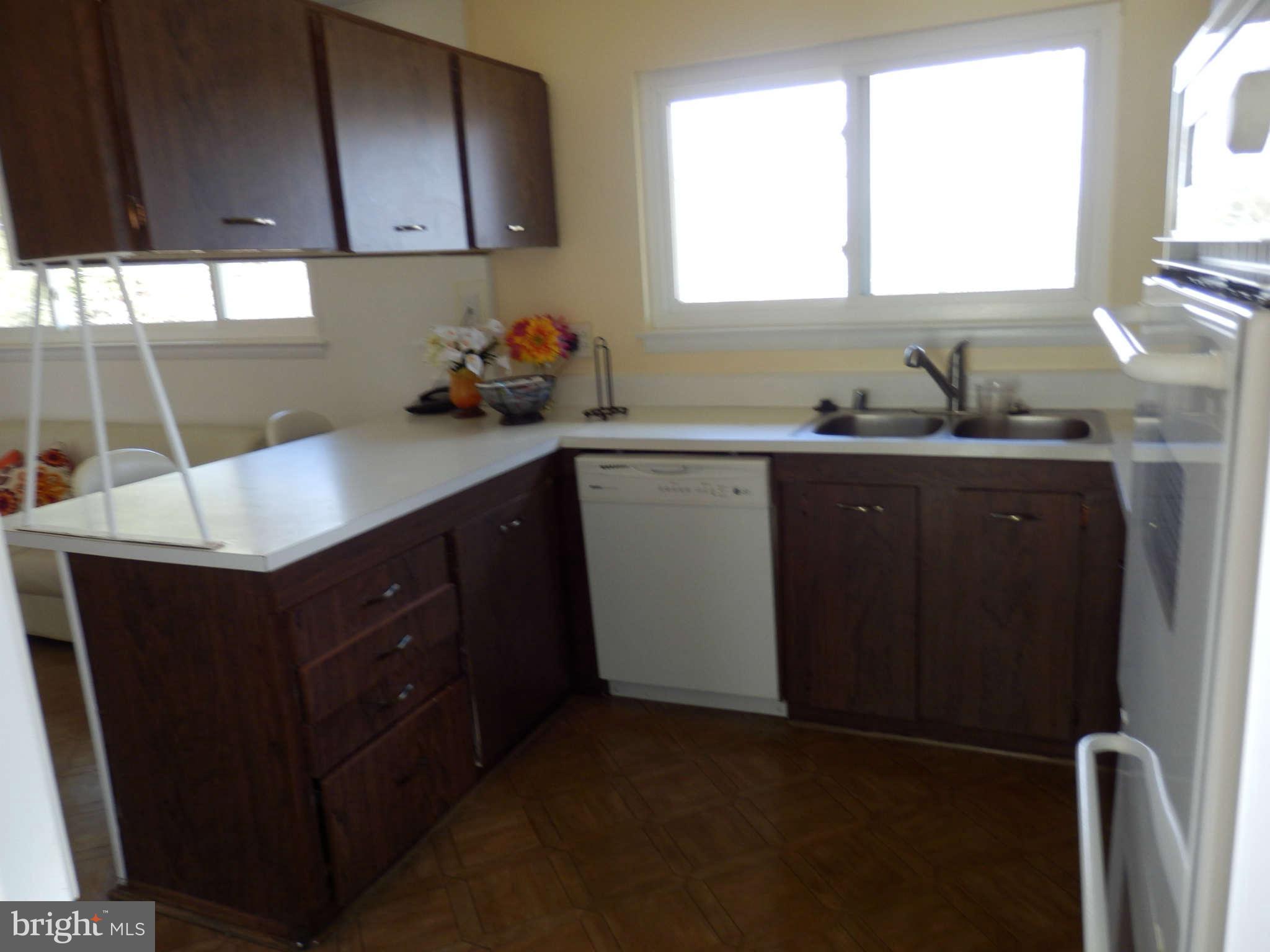 8250 Brattle Road Baltimore, MD 21208 - Photo 10 of 17 a kitchen with a sink cabinets and window