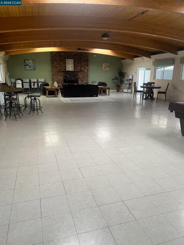 a view of a patio with table and chairs with wooden floor