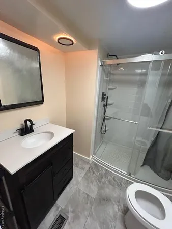 a bathroom with a toilet and a shower