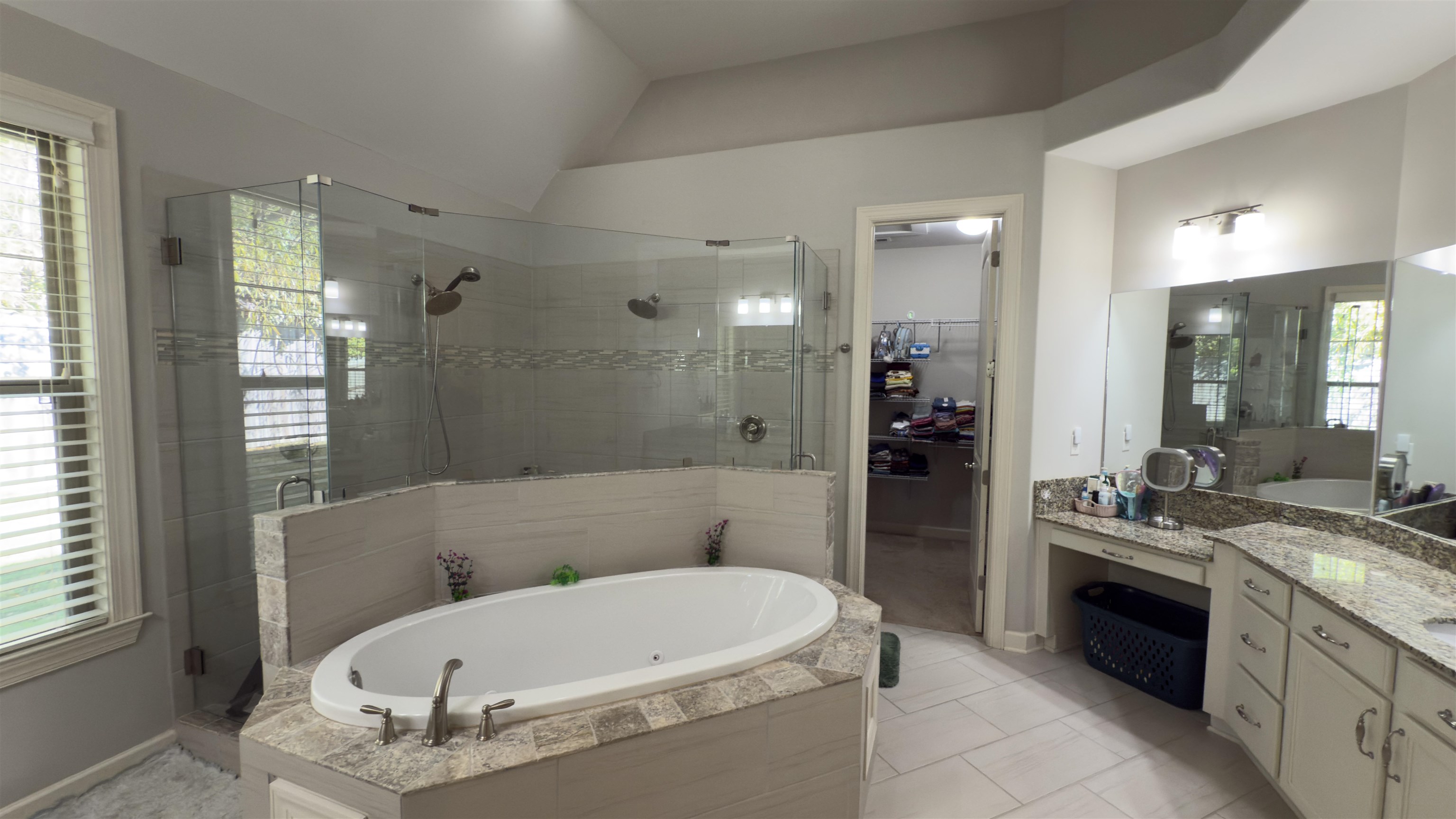 1217 Pilgrim Ridge Road Collierville, TN 38017 - Photo 19 of 33 Full bathroom with a spacious closet, a garden tub, a shower stall, vanity, and vaulted ceiling