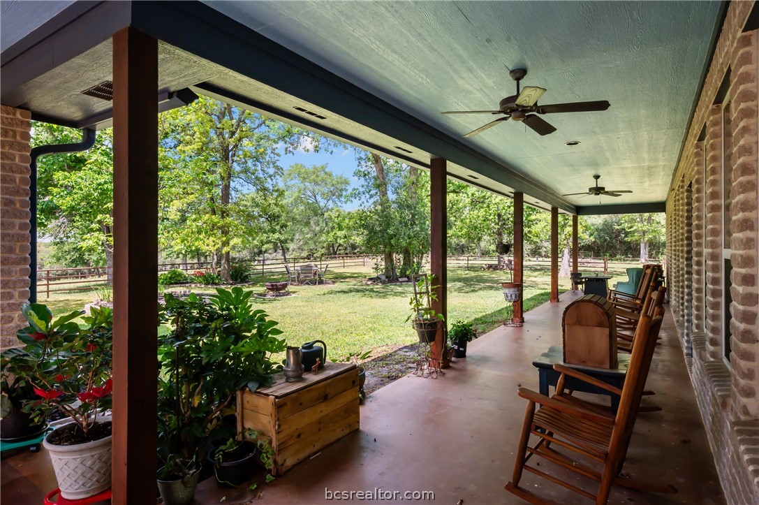 6400 Koppe Bridge Road College Station, TX 77845 - Photo 13 of 47 Fenced backyard with ceiling fans and a covered patio area.