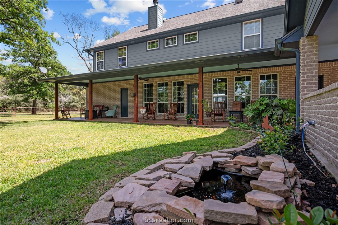 6400 Koppe Bridge Road College Station, TX 77845 - Photo 14 of 47 Rear view of home with ceiling fan, a garden pond, and a patio area.
