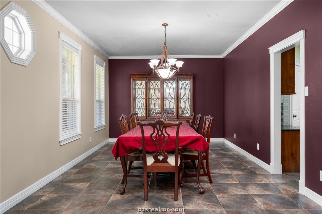6400 Koppe Bridge Road College Station, TX 77845 - Photo 18 of 47 Formal dining area with a chandelier and crown molding.