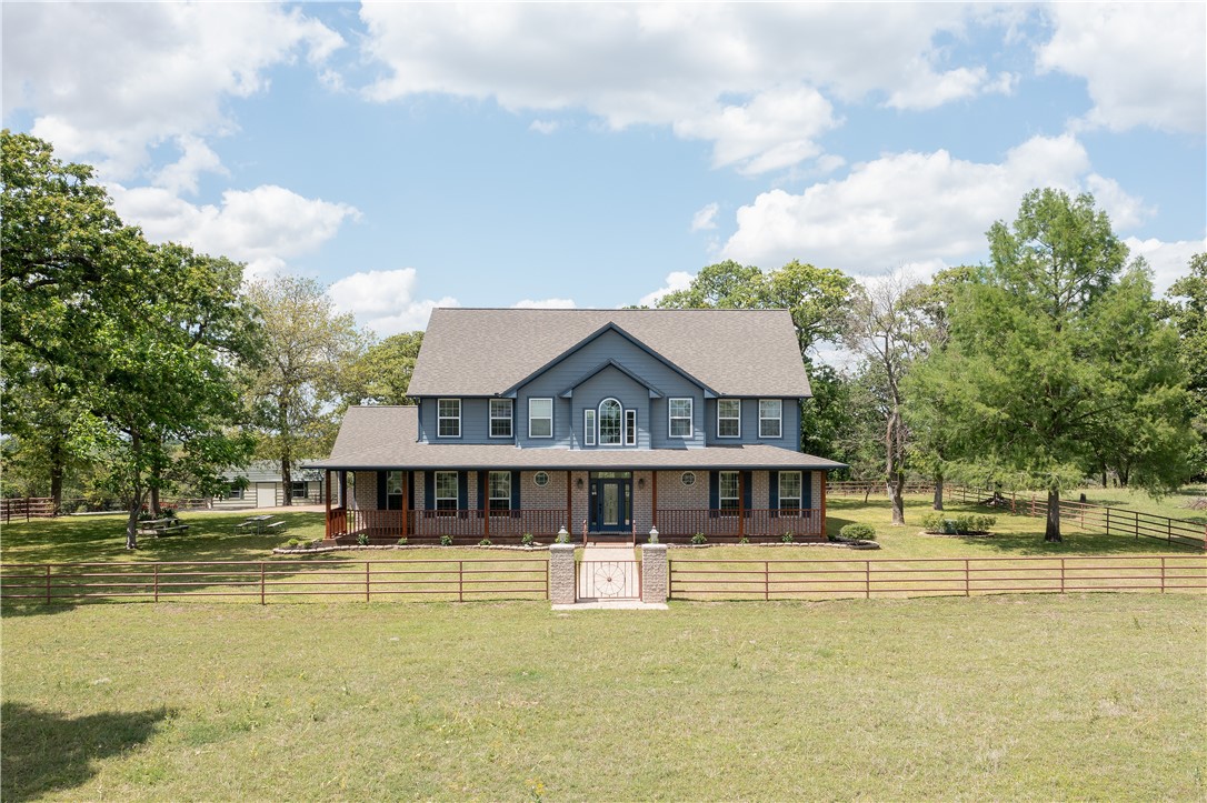 6400 Koppe Bridge Road College Station, TX 77845 - Photo 2 of 47 Colonial inspired home with a porch, a gate, and a fenced front yard.
