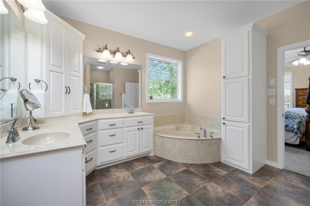 6400 Koppe Bridge Road College Station, TX 77845 - Photo 27 of 47 Ensuite bathroom with double vanity, a stall shower, a ceiling fan, and a garden tub.